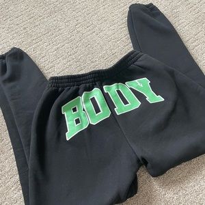 BODY by Raven Tracy ‘Backshot’ sweats in black and green. Snug fit